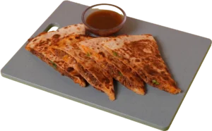 Birria quesadilla sliced into triangles with slow-cooked beef, melted cheese, and a side of dipping consommé on a cutting board.